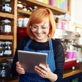 Technology can be used to assist and expand your business. a young woman using a digital tablet while working in a Royalty Free Stock Photo