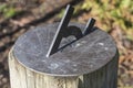 Technology: Close up of a bronze sundial on a simple wooden pedestal. 6