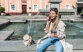 Technology, communication, lifestyle and people concept - smiling young woman or teenage girl calling on smartphone on city street Royalty Free Stock Photo