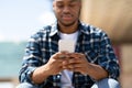 Portrait of black person texting sms on smart phone