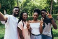 Technology concept. Group of african students taking selfie with phone in campus Royalty Free Stock Photo