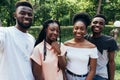 Technology concept. Group of african students taking selfie with phone in campus Royalty Free Stock Photo
