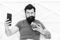 Technology concept. Pleasant conversation. Good morning. Special gift. Bearded man using mobile technology in bed Royalty Free Stock Photo