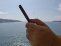 hand of a woman using a smartphone in a place of tropical climate