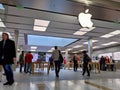 Technology crazed customers shopping inside an Apple store, scoping out iPhones and