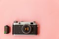 Vintage film photo camera lens and film roll on pink pastel trendy background Royalty Free Stock Photo