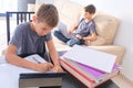 Technology, education, online learning, distance learning at home. Boy start doing mathematics homework with books and