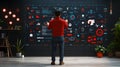 Technology Enthusiast Analyzing Data Visualizations in a Modern Workspace with Futuristic Wall Graphics Royalty Free Stock Photo