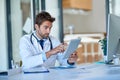 Technology is every practitioners best friend. a young doctor working on a digital tablet in his office. Royalty Free Stock Photo