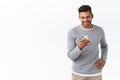 Technology, futuristic concept. Handsome carefree modern guy chatting with friends via smartphone messanger, holding Royalty Free Stock Photo