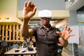 Technology, gaming, entertainment and people concept. African man wearing casual and virtual reality headset or 3d Royalty Free Stock Photo