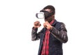 African man wearing formal suit and virtual reality headset or 3d glasses, playing video game, gesturing with his hands and catchi Royalty Free Stock Photo