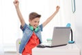 Boy with headphones playing video game on laptop Royalty Free Stock Photo