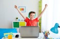 Boy with headphones playing video game on laptop Royalty Free Stock Photo