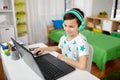 Boy in headphones playing video game on laptop Royalty Free Stock Photo