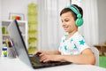 Boy in headphones playing video game on laptop Royalty Free Stock Photo