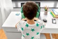 Boy in headphones playing video game on laptop Royalty Free Stock Photo