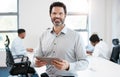 technology helps me engage better with others too. Portrait of a confident mature businessman using a digital tablet in Royalty Free Stock Photo