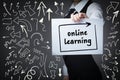 Technology, internet, business and marketing. Young business woman writing word:online learning