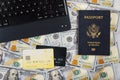 Technology and internet computer keyboard, hundred US dollar bills on buying a ticket online with credit card on American passport Royalty Free Stock Photo
