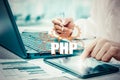 Technology and internet concept - businessman holds the php button on virtual screens