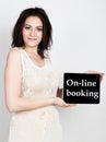 Technology, internet and networking - close-up successful woman holding a tablet pc with on-line booking sign. internet