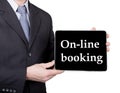 Technology, internet and networking in tourism concept - businessman holding a tablet pc with on-line booking sign