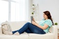 Happy young plus size woman with tablet pc at home