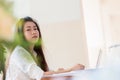 Technology Learning concept: Asian Young woman student learning and check timetable for projected in laptop computer at busy table