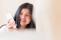 Technology Learning concept: Closeup shot of Asian Happy Young woman student smiling with smartphone for selfies photo camera with