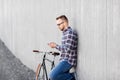 Hipster man in earphones with smartphone and bike Royalty Free Stock Photo