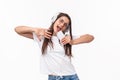 Technology, lifestyle and music concept. Carefree, enthusiastic young chilling woman having fun, girl dancing to