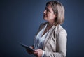 Technology makes business simple. Studio shot of an attractive young corporate businesswoman using a tablet against a