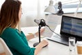 woman with microphone recording podcast at studio Royalty Free Stock Photo