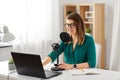 Woman with microphone recording podcast at studio Royalty Free Stock Photo