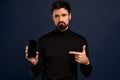 Technology, people and communication concept.Portrait of upset and disappointed,gloomy bearded caucasian man pointing finger at