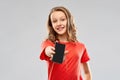 Smiling teenage showing smartphone