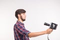 Technology, photography and people concept - Funny man in plaid shirt taking a selfie over white background Royalty Free Stock Photo