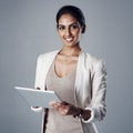Technology, portrait of a businesswoman with tablet and against a studio background for connectivity. Online Royalty Free Stock Photo