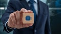 Technology professional holding wooden cube with microchip icon symbolizing artificial intelligence, digital innovation and IT Royalty Free Stock Photo