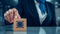 Technology professional holding wooden cube with microchip icon symbolizing artificial intelligence, digital innovation and IT Royalty Free Stock Photo