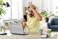 Angry indian man with smartphone at home office