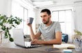 Man with laptop drinking coffee at home office Royalty Free Stock Photo