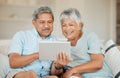 Technology, senior and couple with tablet happy on sofa in living room of their home. Connectivity or social networking Royalty Free Stock Photo