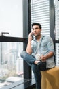 Technology Smartphone and Communication Concept, Portrait of Business Handsome Man is Calling on Cellphone at Office Workplace. Royalty Free Stock Photo