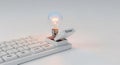 Technology Startup Concept: Glowing Idea Bulb Springs from Enter Key on White Keyboard. Royalty Free Stock Photo