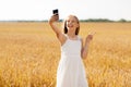 Girl taking selfie by smartphone and showing peace Royalty Free Stock Photo