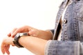 Technology, time, fast life. Woman in denim jacket looking at her wrist watch