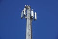 Technology on the top of the telecommunication GSM 4G tower antenna, transmitter , blue sky, white clouds.