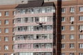 Unmanned aerial vehicle - a quad copter with a camera and video broadcast flies against a brick apartment building